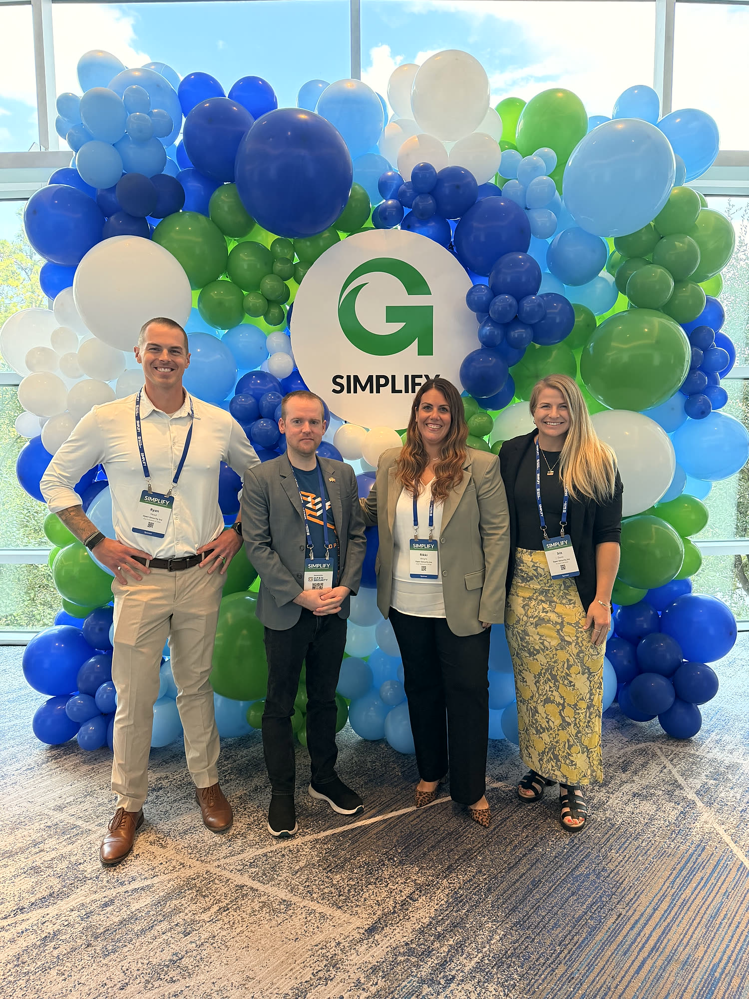 Team photo at the Simplify 2026 balloon wall